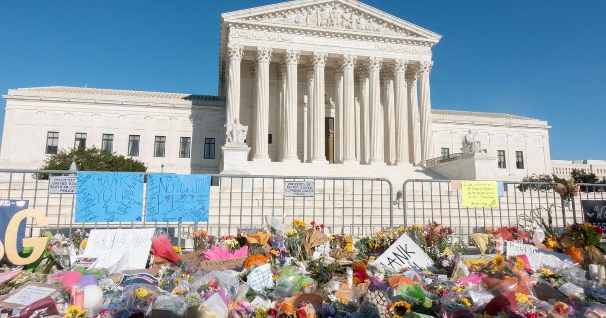 Flowers left as a memorial to Ruth Bader Ginsburg in front of SCOTUS