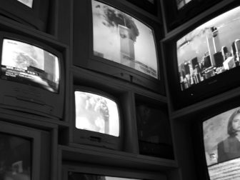 Black & White Multiple TV Sets displaying the news