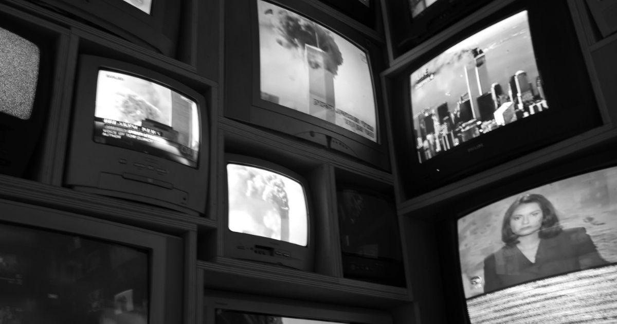 Black & White Multiple TV Sets displaying the news