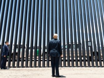 President Donald J. Trump stands before a plaque Tuesday, June 23, 2020, commemorating the 200th mile of new border wall along the U.S.-Mexico border near Yuma, Ariz. (Official White House Photo by Shealah Craighead)
