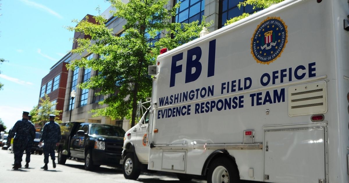 WASHINGTON (Sept. 18, 2013) An F.B.I. evidence response team collects evidence at Building 197 at the Washington Navy Yard. A gunman killed 12 people at the base Sept. 16, 2013.