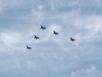 Five fighter jets in flight.