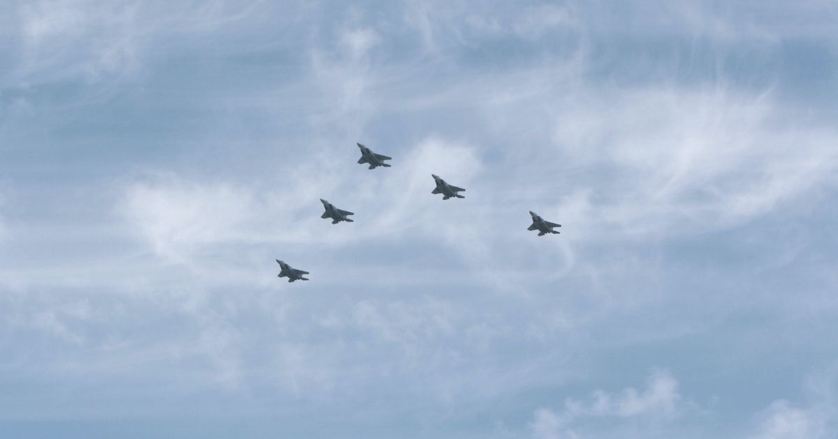 Five fighter jets in flight.