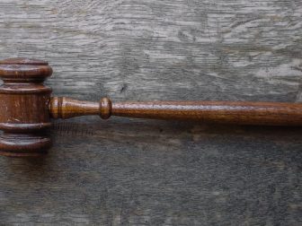 Brown gavel on a wooden table