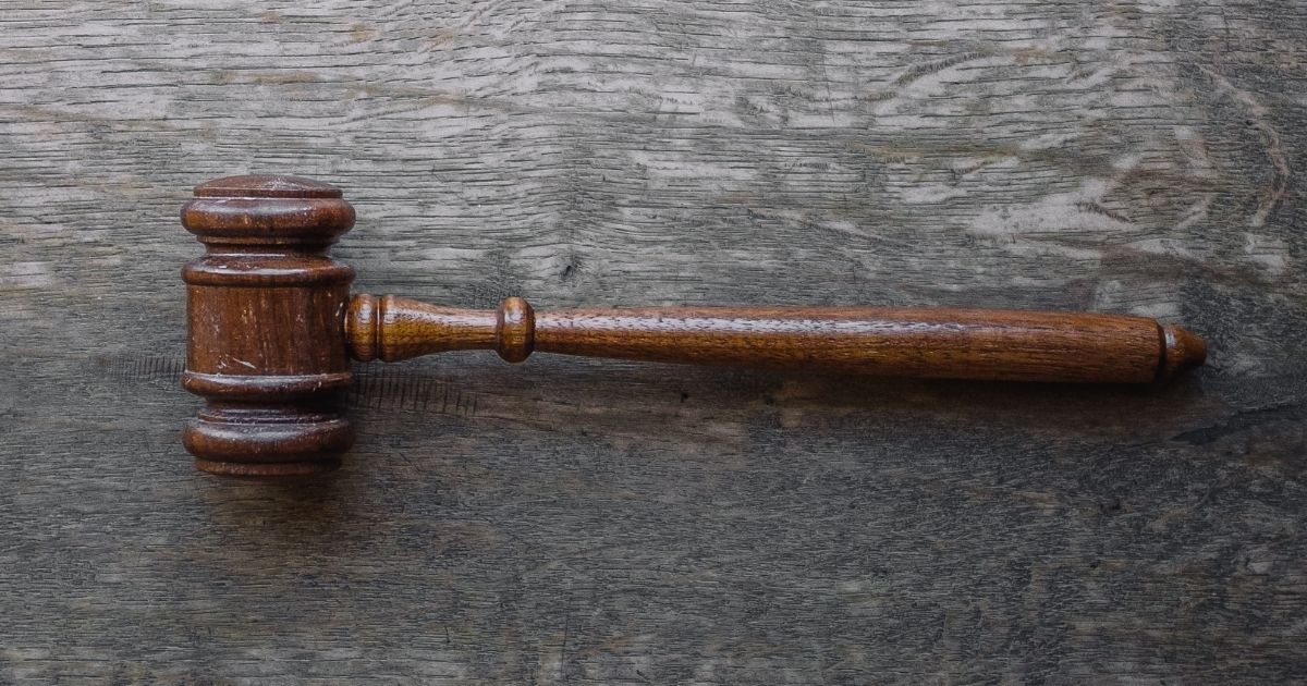 Brown gavel on a wooden table