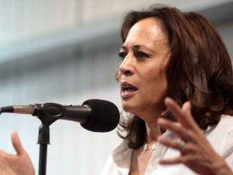 Kamala Harris speaking into microphone