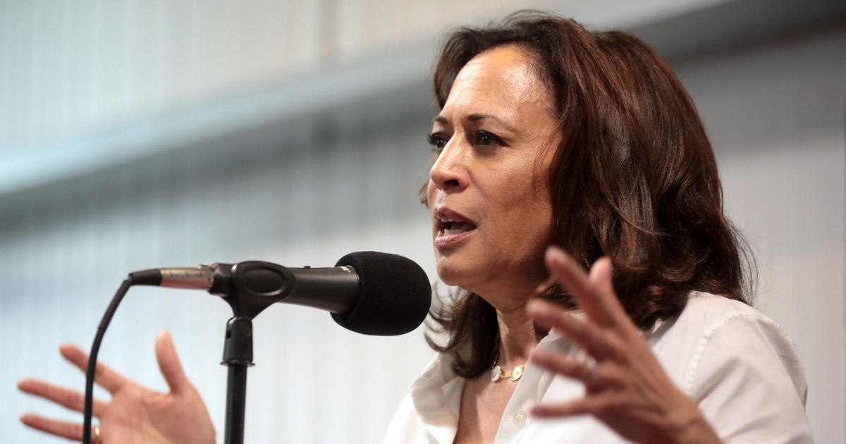 Kamala Harris speaking into microphone