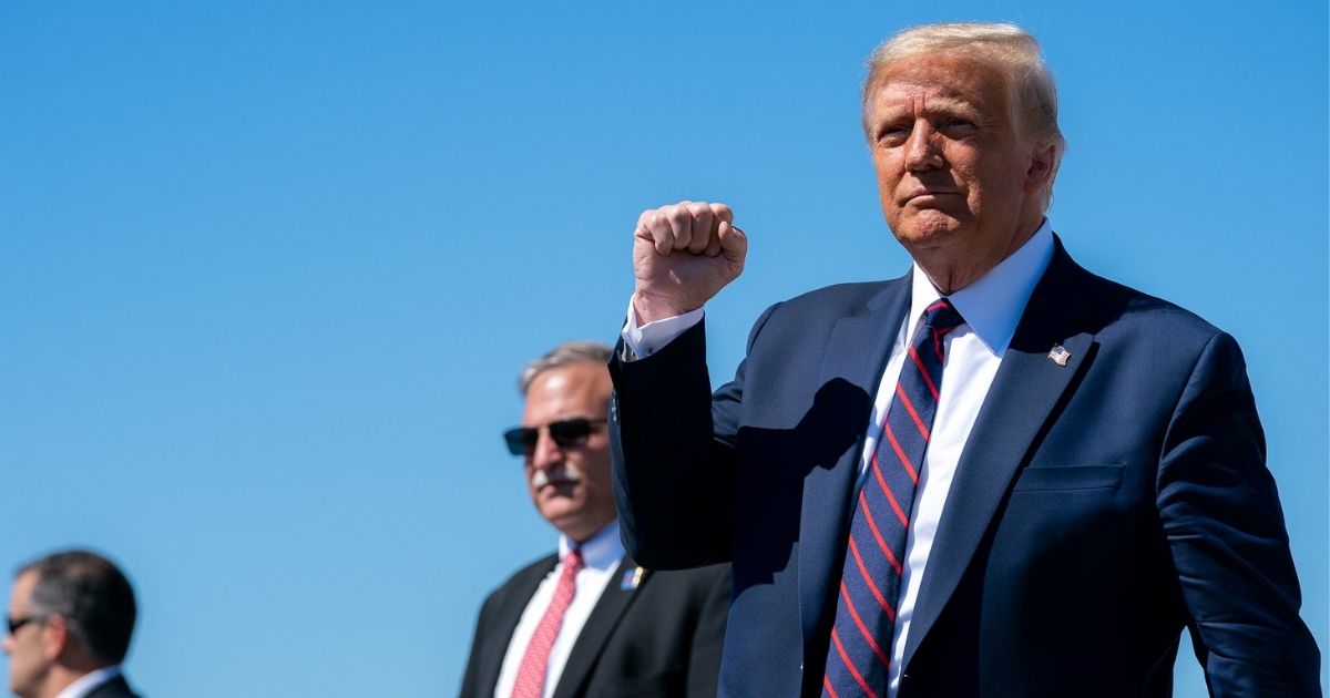 President Donald J. Trump gestures with a fist-pump as he disembarks Air Force One at Wilkes-Barre Scranton International Airport in Avoca, Pa., Thursday, August 20, 2020, and Is greeted by guests and supporters. (Official White House Photo by Tia Dufour)