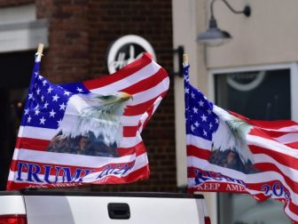 Trump 2020 flags in back of pickup truck