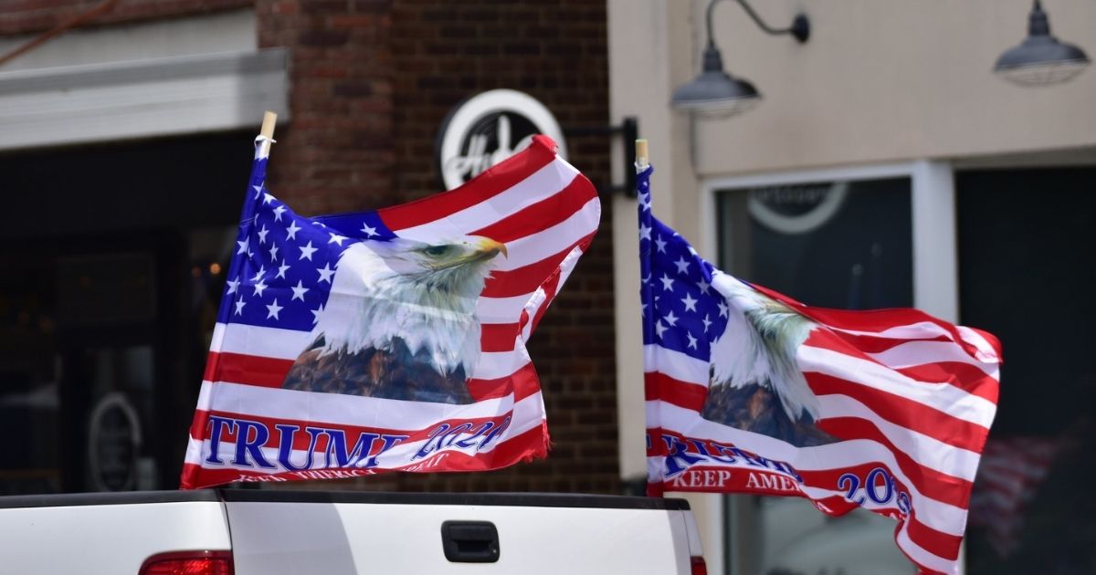 Trump 2020 flags in back of pickup truck