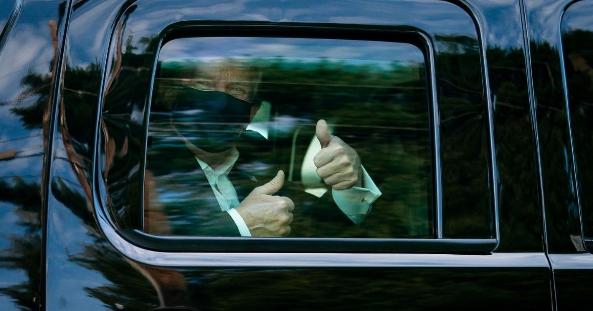 President Donald J. Trump greets supporters during a drive by outside of Walter Reed National Military Medical Center Sunday, Oct. 4, 2020, in Bethesda, Md. (Official White House Photo by Tia Dufour)