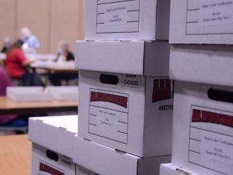 Boxes of ballots are seen stacked for hand counting in Juneau, Alaska's Centennial Hall following Alaska's Aug. 18, 2020 statewide primary. (James Brooks photo)