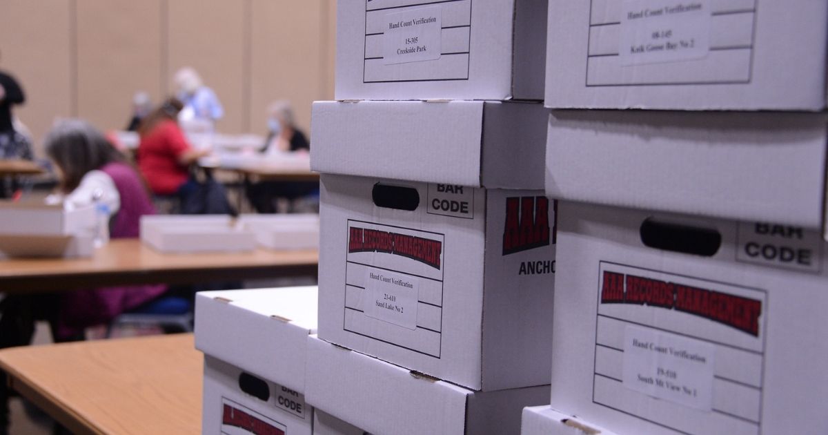 Boxes of ballots are seen stacked for hand counting in Juneau, Alaska's Centennial Hall following Alaska's Aug. 18, 2020 statewide primary. (James Brooks photo)