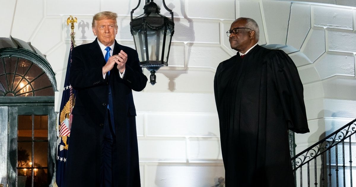 President Donald J. Trump, joined by associate U.S. Supreme Court Justice Clarence Thomas, applauds Amy Coney Barrett following her swearing-in as Associate Justice of the U.S. Supreme Court Monday, Oct. 26, 2020, on the South Lawn of the White House. (Official White House photo by Tia Dufour)