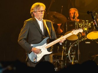 Eric Clapton playing guitar in concert