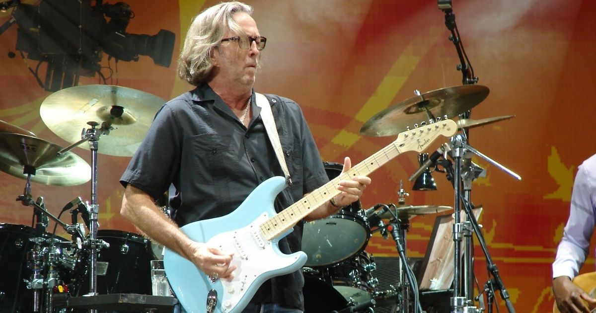 Eric Clapton playing a blue guitar