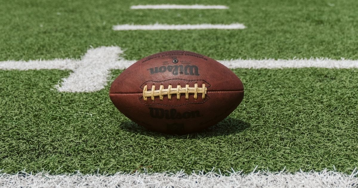 Brown and black Wilson football on a football field.