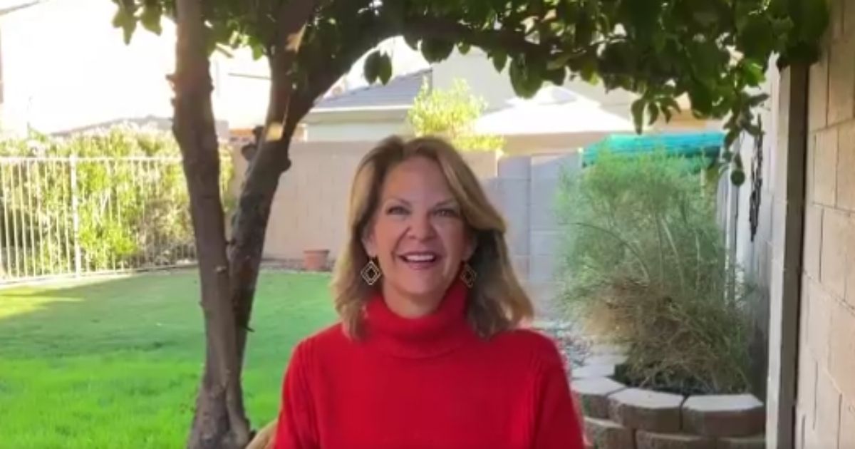 Arizona Republican Party chair Kelli Ward encourages supporters of President Donald Trump on Monday.