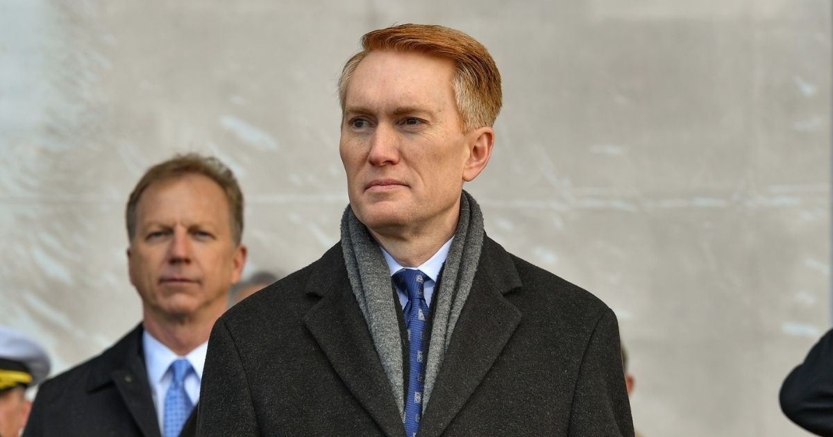 Sen. James Lankford (R-OK) stands for the parading of the colors during the commissioning ceremony of littoral combat ship USS Tulsa (LCS 16). LCS 16 is the fifteenth littoral combat ship to enter the fleet and the eighth of the Independence variant.
