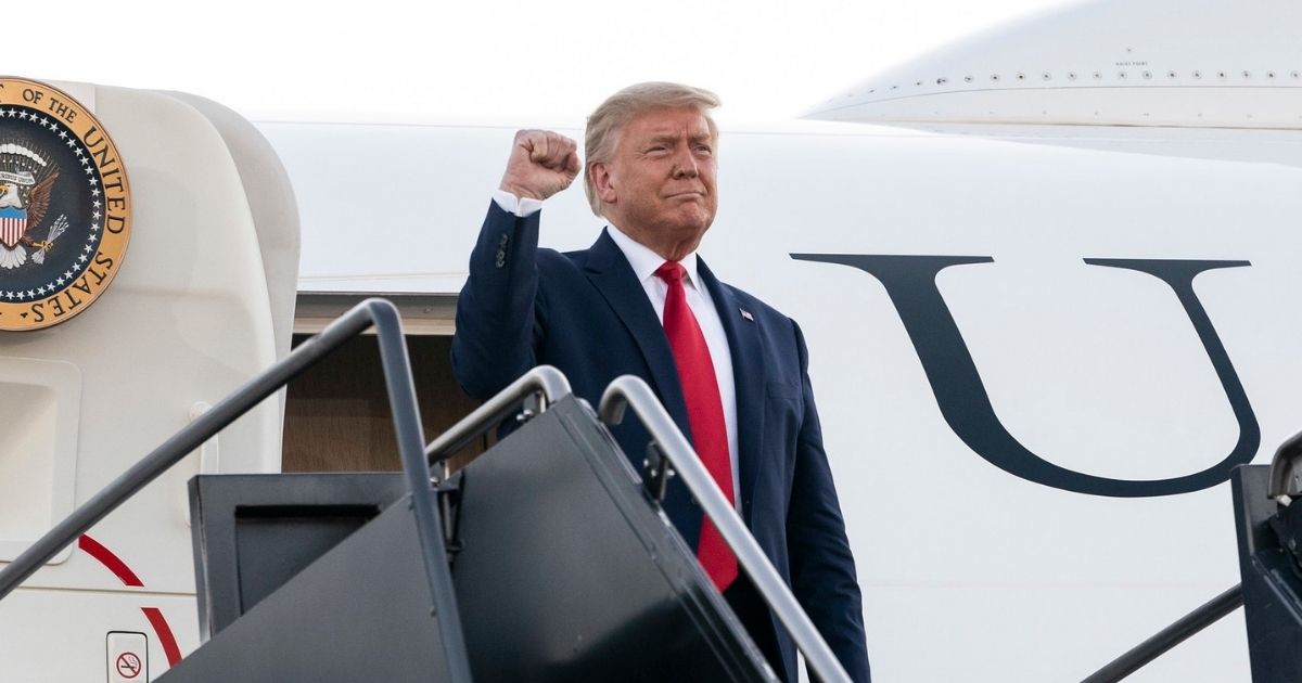 President Donald J. Trump offers a fist-pump to an awaiting crowd as he steps from Air Force One Friday, Aug. 28, 2020, upon his arrival to Manchester-Boston Regional Airport in Manchester, N.H. (Official White House Photo by Joyce N. Boghosian)