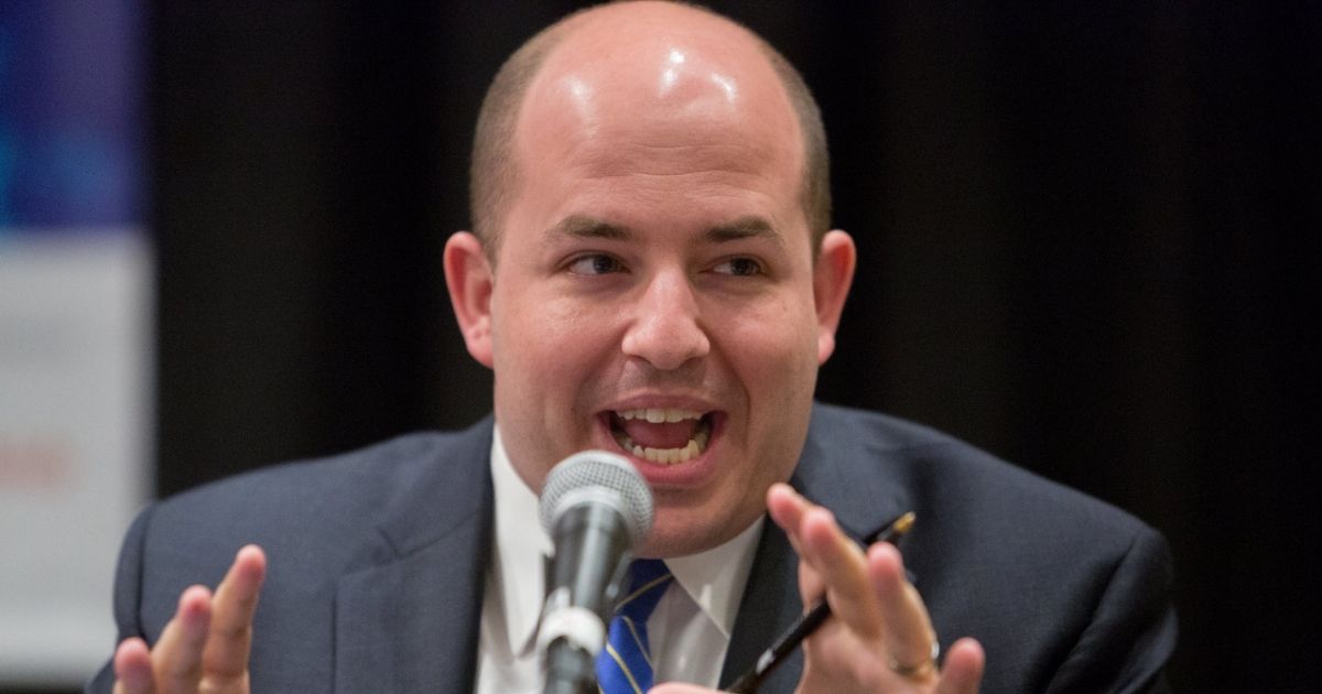 Brian Stelter speaking into a microphone.