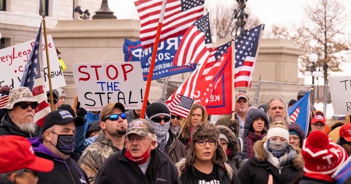 On a day that saw Minnesota break a record high of 8,703 COVID cases, far-right conspiracy theorists Qanon and "Stop The Steal" followers stood maskless shoulder to shoulder outside the Minnesota State Capitol. Speakers led the crowd in bizarre covid/election chants.