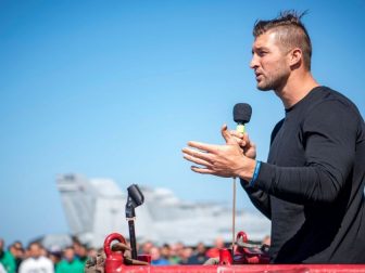 Tim Tebow addresses Sailors on the flight deck of Nimitz-class aircraft carrier USS Carl Vinson (CVN 70) during a visit to the ship. (U.S. Navy photo by Mass Communication Specialist 3rd Class Michele Fink/Released)