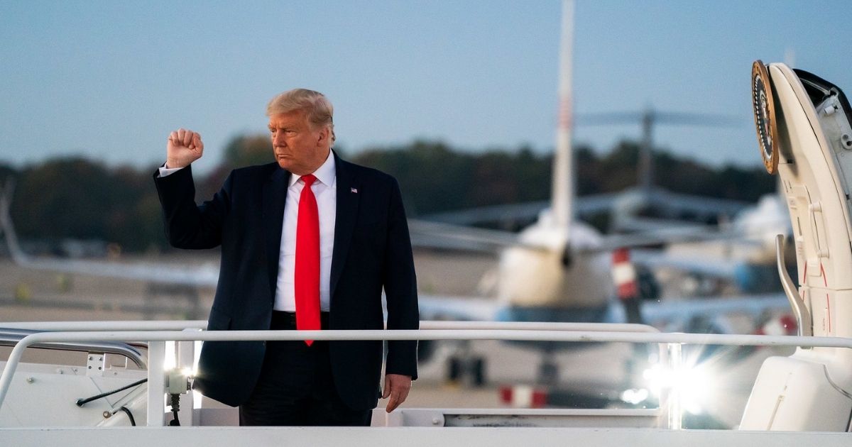 President Donald J. Trump boards Air Force One at Joint Base Andrews, Md. Tuesday, Oct. 20, 2020, en route to Erie International Airport in Erie, Pa. (Official White House Photo by Tia Dufour)