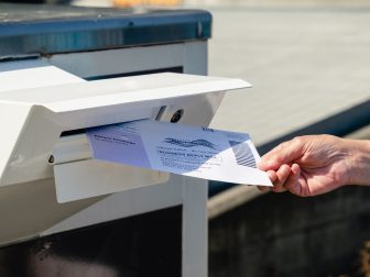 Everett, WA - USA / 07/30/2020: Dropping Mail in Ballot into mail box