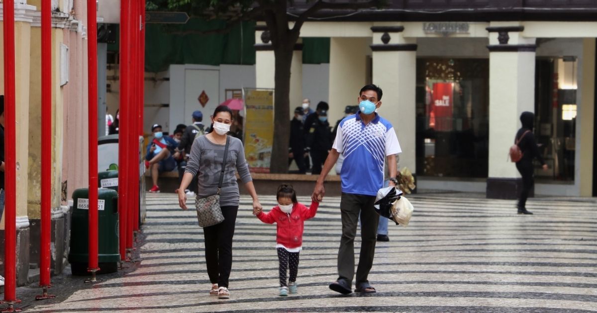 Family walking at Macau's Senado Square wearing protective face masks due to coronavirus (Covid-19) outbreak.