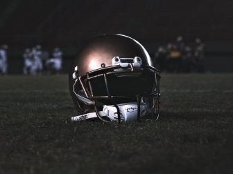 Football helmet on a grass field