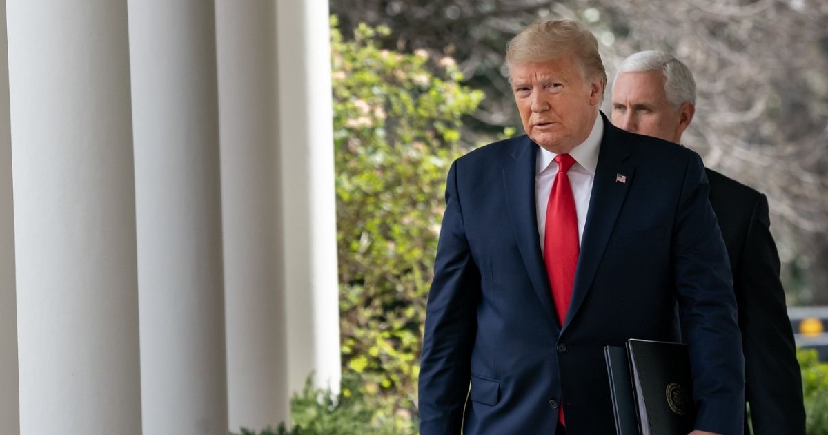 President Donald J. Trump, joined by Vice President Mike Pence, walks to a news conference Friday, March 13, 2020, in the Rose Garden of the White House. (Official White House Photo by D.Myles Cullen)