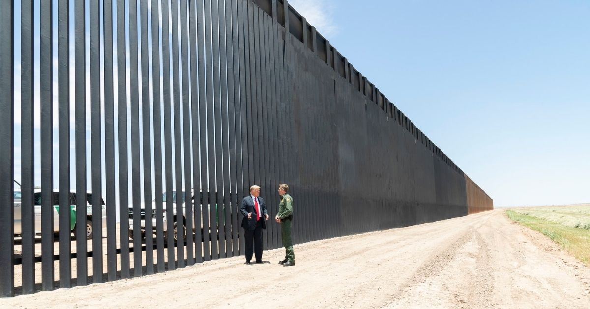 President Donald J. Trump meets U.S. Border Patrol Chief Rodney Scott as he walks along the completed 200th mile of new border wall Tuesday, June 23, 2020, along the U.S.-Mexico border near Yuma, Ariz. (Official White House Photo by Shealah Craighead)