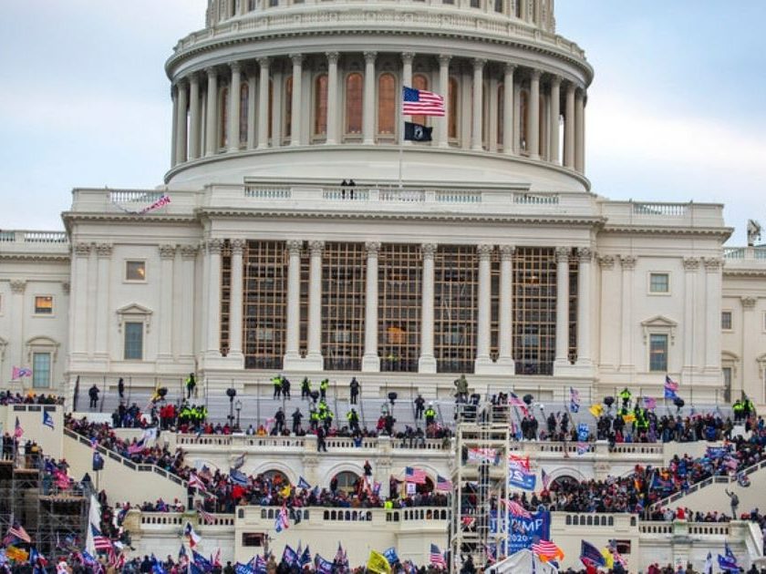 A large group of pro-Trump protesters stand on the East steps of the Capitol Building after storming its grounds on Jan. 6 in Washington, D.C.