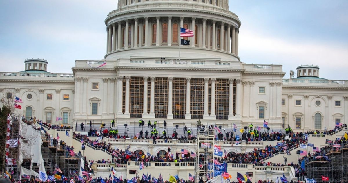 A large group of pro-Trump protesters stand on the East steps of the Capitol Building after storming its grounds on Jan. 6 in Washington, D.C.