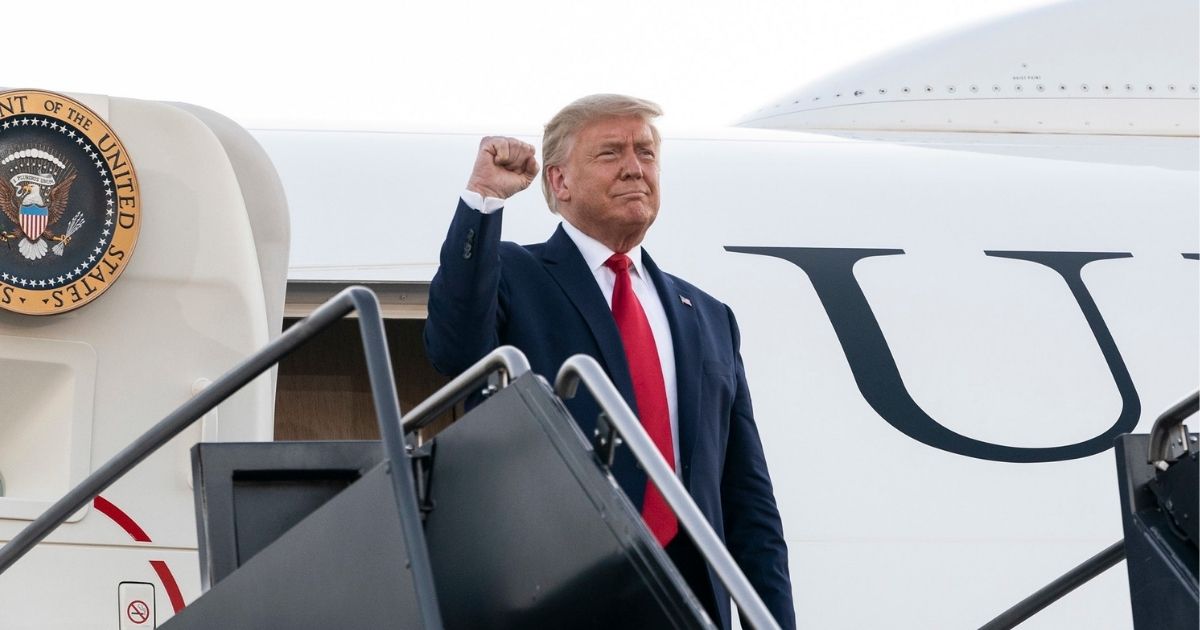 President Donald J. Trump offers a fist-pump to an awaiting crowd as he steps from Air Force One Friday, Aug. 28, 2020, upon his arrival to Manchester-Boston Regional Airport in Manchester, N.H. (Official White House Photo by Joyce N. Boghosian)