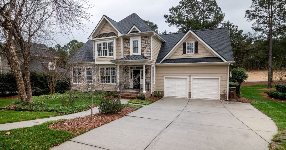 White and brown wood house near bare trees