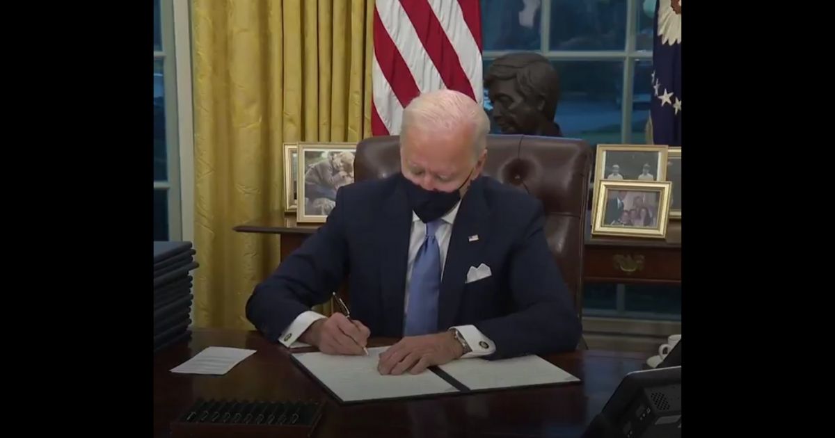 President Joe Biden signs an executive order after his inauguration as president of the United States on Wednesday in Washington, D.C.