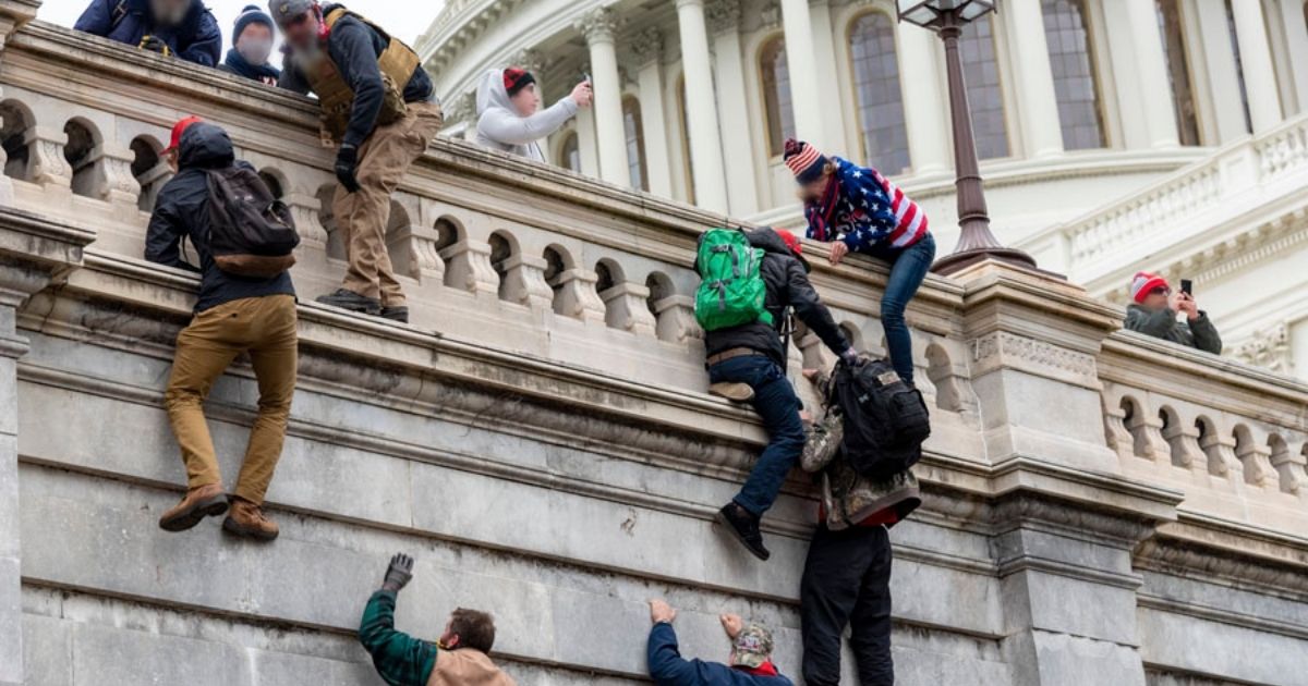 Protesters scaling wall at Capitol