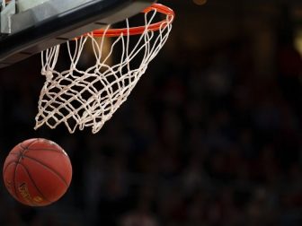 Basketball falling through a hoop