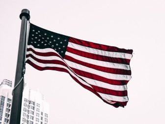US flag flying in the city