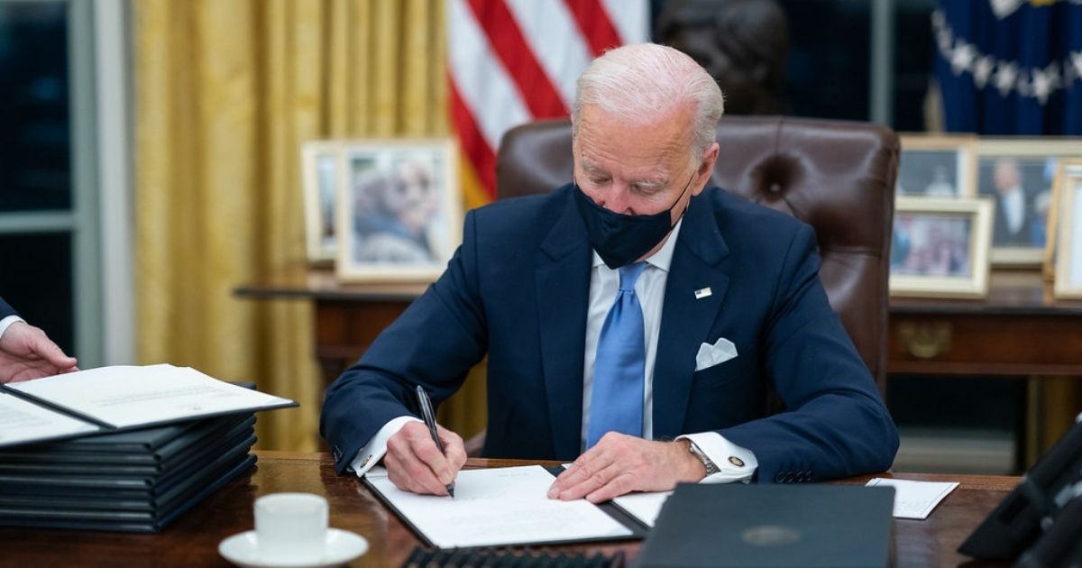 President Joe Biden signs one of the 17 Executive Orders he signed on Inauguration Day Wednesday, Jan. 20, 2021, in the Oval Officeof the White House. (Official White House Photo by Adam Schultz)