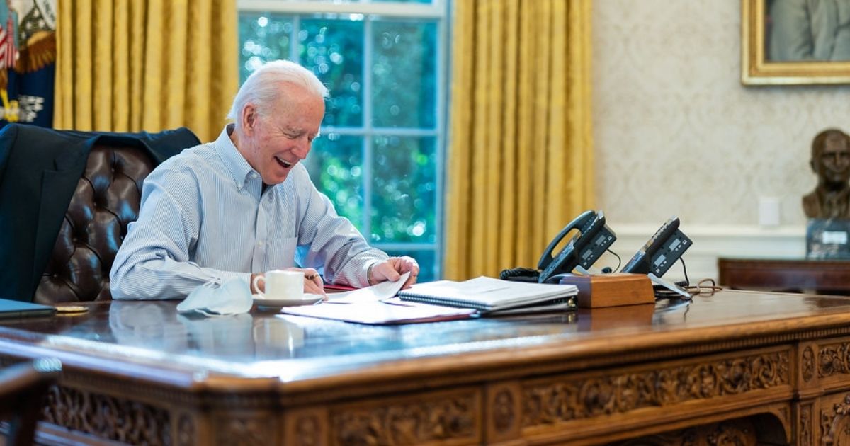 President Joe Biden talks on the phone with British Prime Minister Boris Johnson Saturday, Jan. 23, 2021, in the Oval Office of the White House. (Official White House Photo by Adam Schultz)