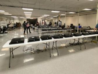 Auditors examine Dominion Voting Systems machines in Maricopa County, Arizona. Officials said Tuesday that audits by two independent firms found the county's Dominion machines were not hacked and accurately counted the ballots in November's elections.