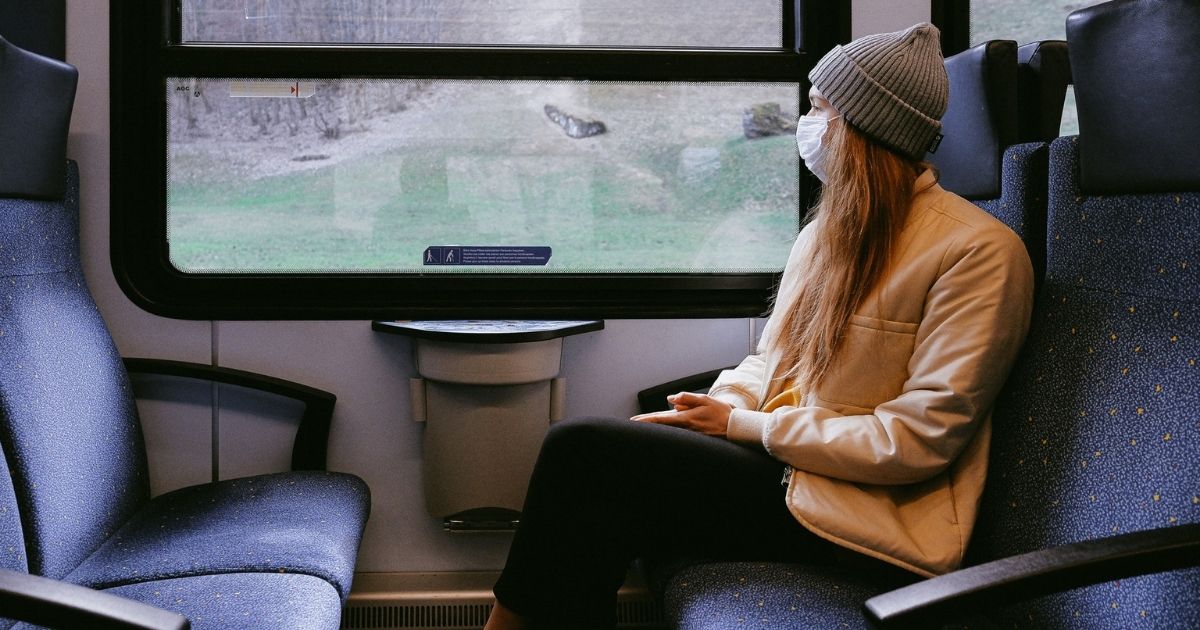 Woman wearing mask on train