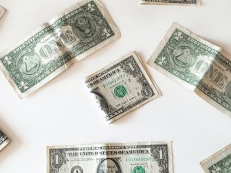 Dollar bills on a white surface