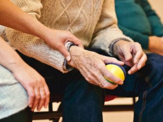 Elderly person holding a stress ball