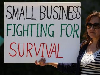 Rally goer holds up a "Small Business fighting for survival" sign ar ReOpen NC rally in Raleigh, NC.