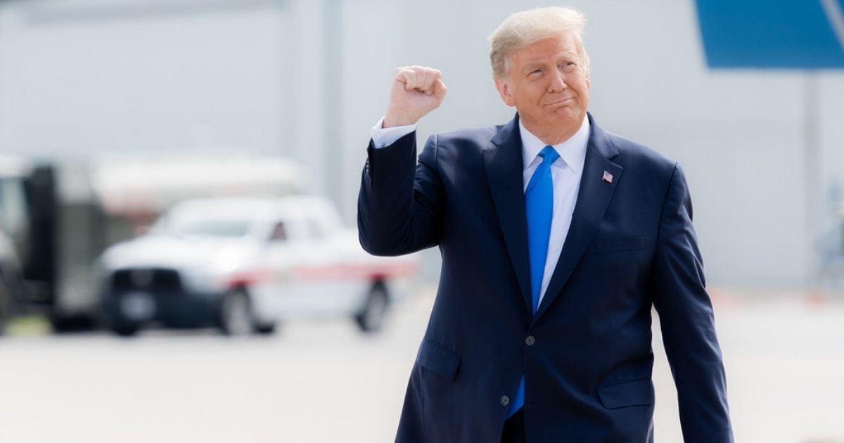 President Donald J. Trump gestures with a fist pump as he walks across the tarmac upon his arrival Thursday, Oct. 15, 2020, to Pitt-Greenville Airport in Greenville, S.C. (Official White House Photo by Shealah Craighead)