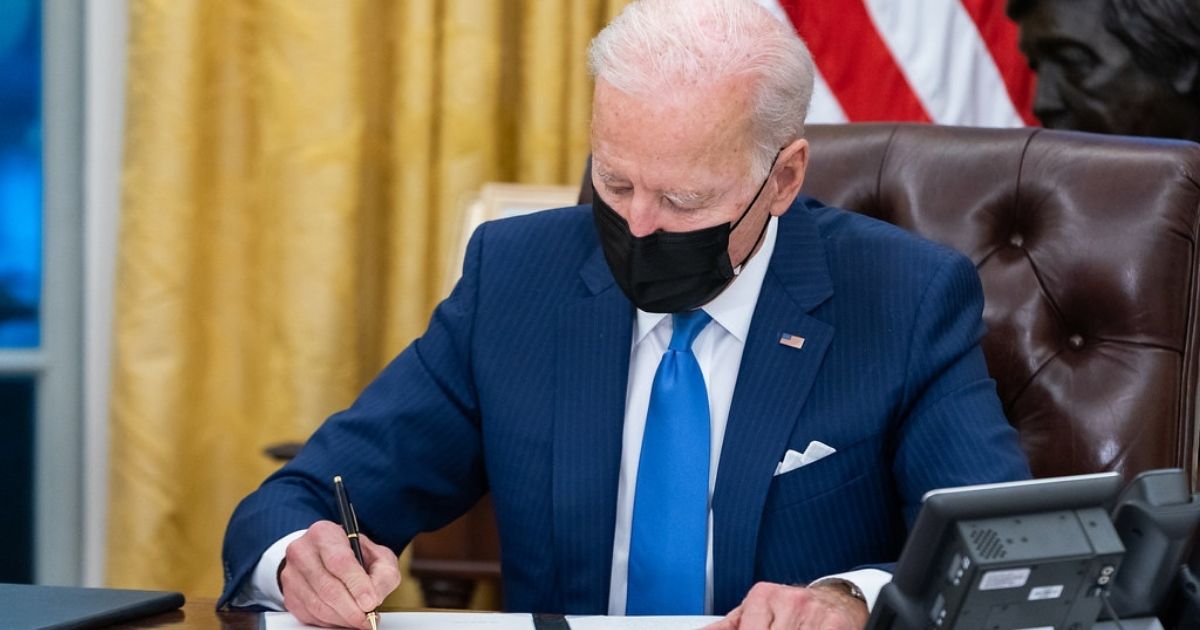 President Joe Biden signs executive orders on immigration Tuesday, Feb. 2, 2021, in the Oval Office of the White House. (Official White House Photo by Adam Schultz)